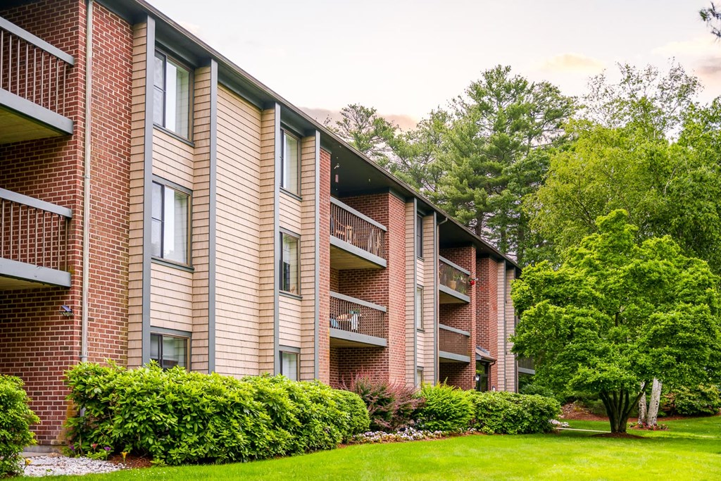 Stone run east apartment building exterior with lush landscaping