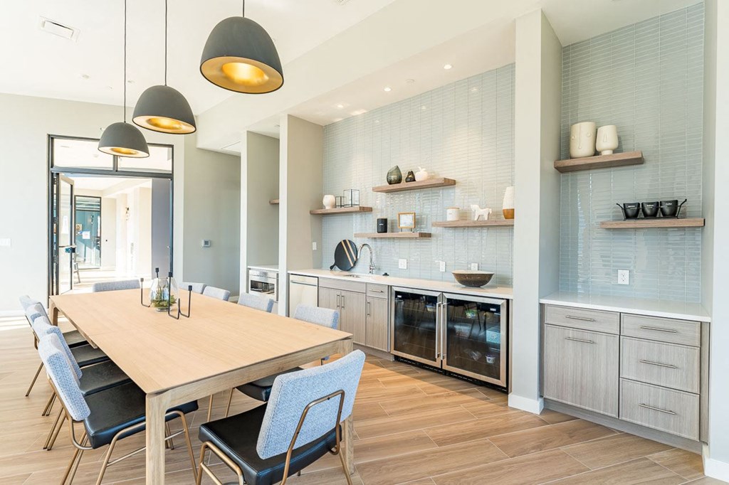 Clubhouse lounge kitchen with fridge and sink with dining table