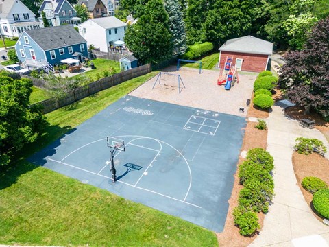 an aerial view of a basketball court and playground