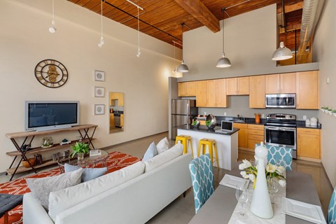 a living room with a white couch and a table with chairs