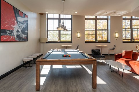 Community lounge at building 240 with pool table and lounge seating