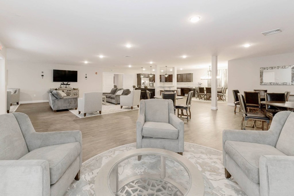 A living room with grey couches and a television.