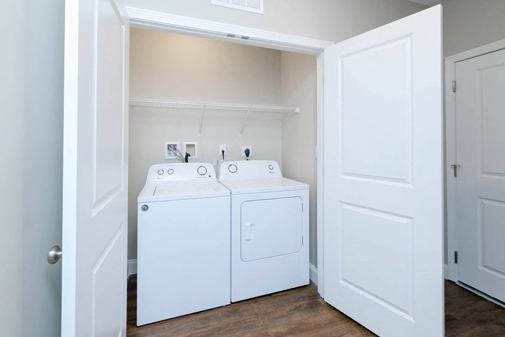 A white laundry room with a washer and dryer.