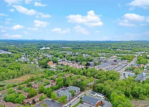 A small town with a lot of greenery and a few buildings.