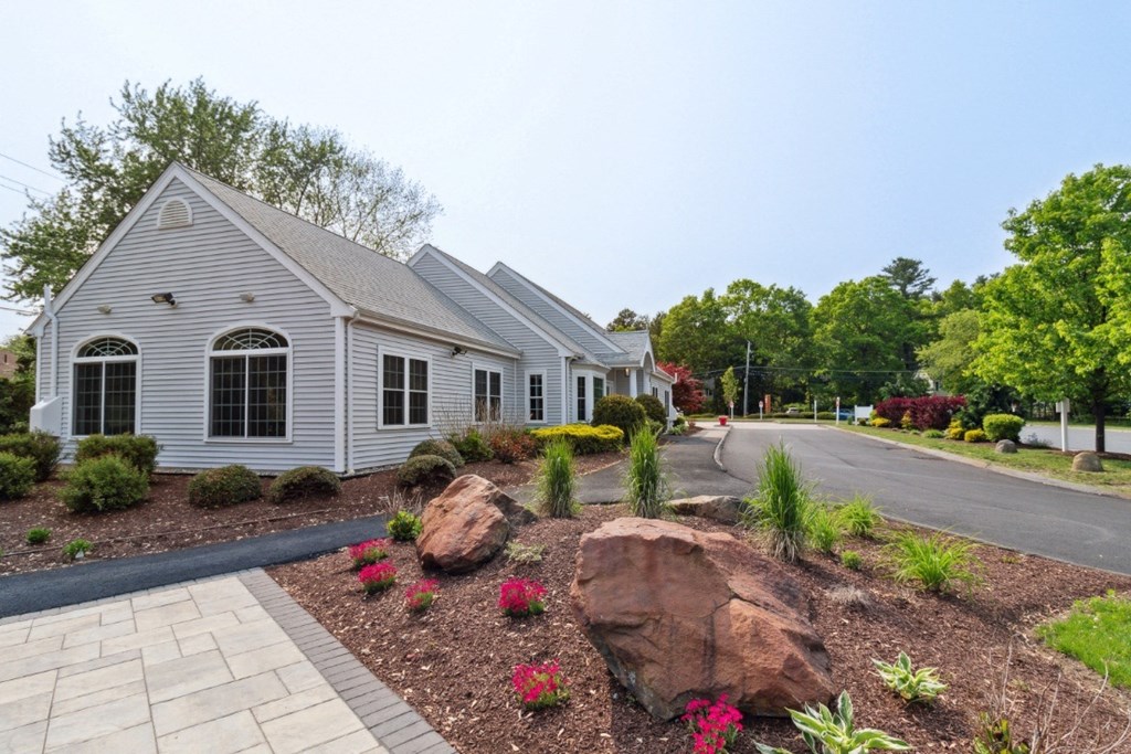 Building Exterior with Beautiful Landscaping at Mansfield Meadows Apartments.