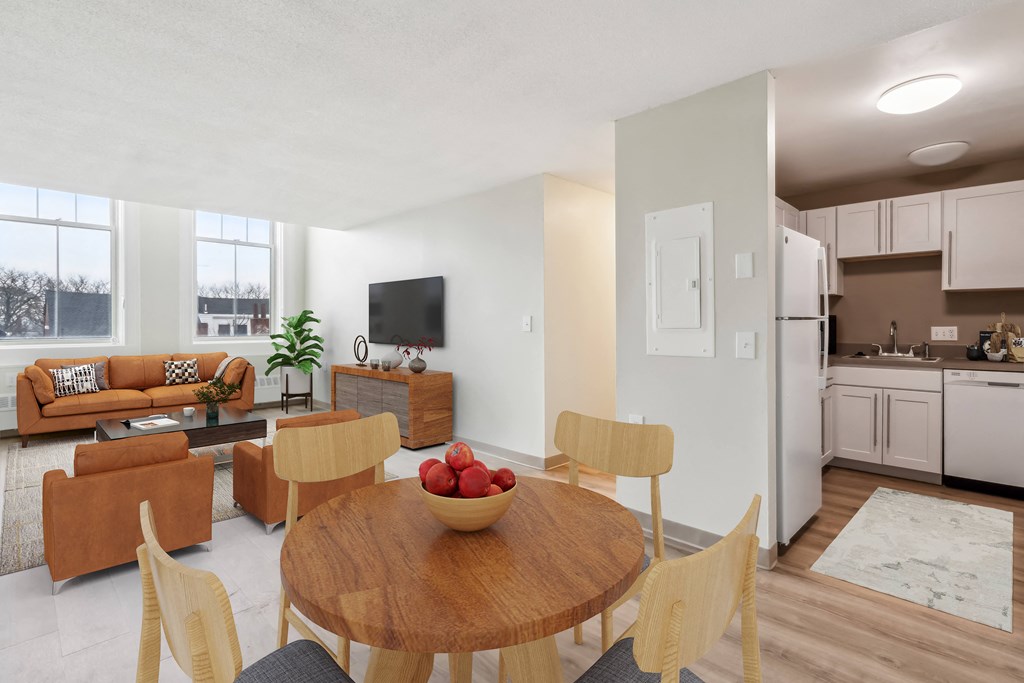 a living room and dining room with a table and chairs at Chapman House, E. Boston, MA