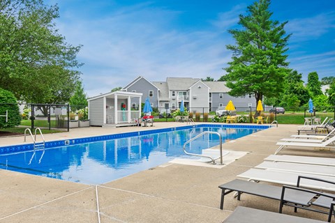 our apartments have a large swimming pool and lounge chairs at Blue Hills Village, Canton, Massachusetts