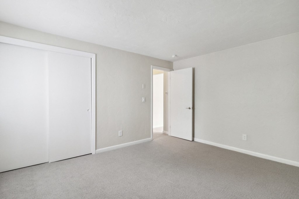 Apartment Bedroom Building Exterior with Beautiful Landscaping at Mansfield Meadows Apartments.