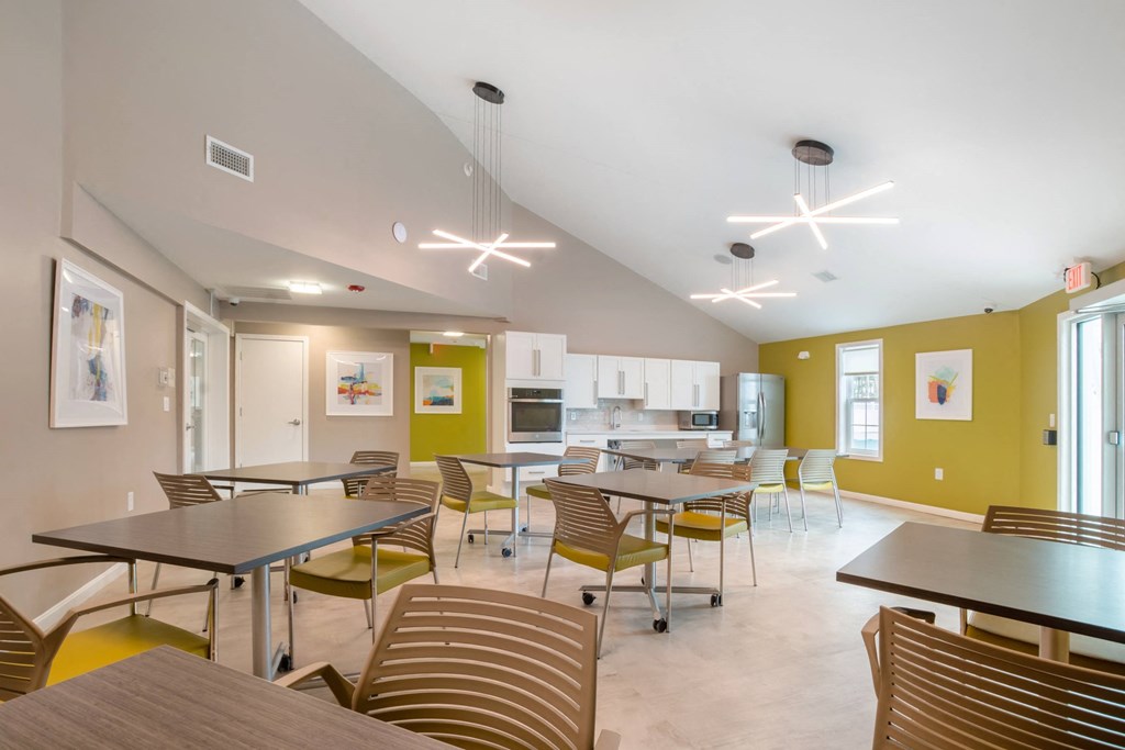 Community room with tables and chairs at Station Pointe Apartments, Mansfield, MA, 02048