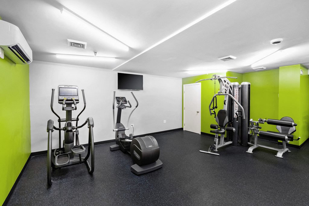 a gym with exercise equipment and green and white wallsat North Stoughton Village, Stoughton, MA