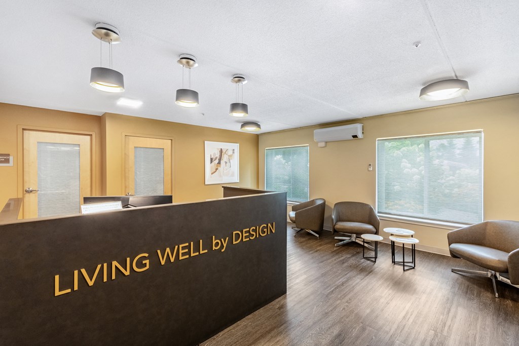 a living well by design lobby with chairs and a reception desk at North Stoughton Village, Massachusetts