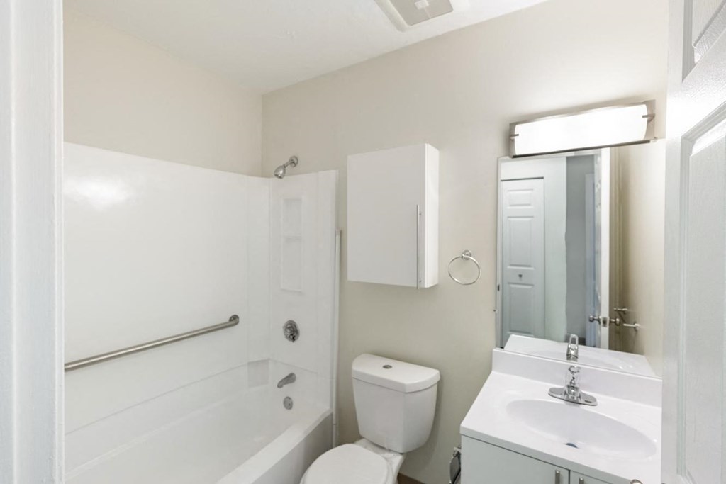 A updated bathroom with a tub at North Stoughton Village Apartments in Stoughton, MA