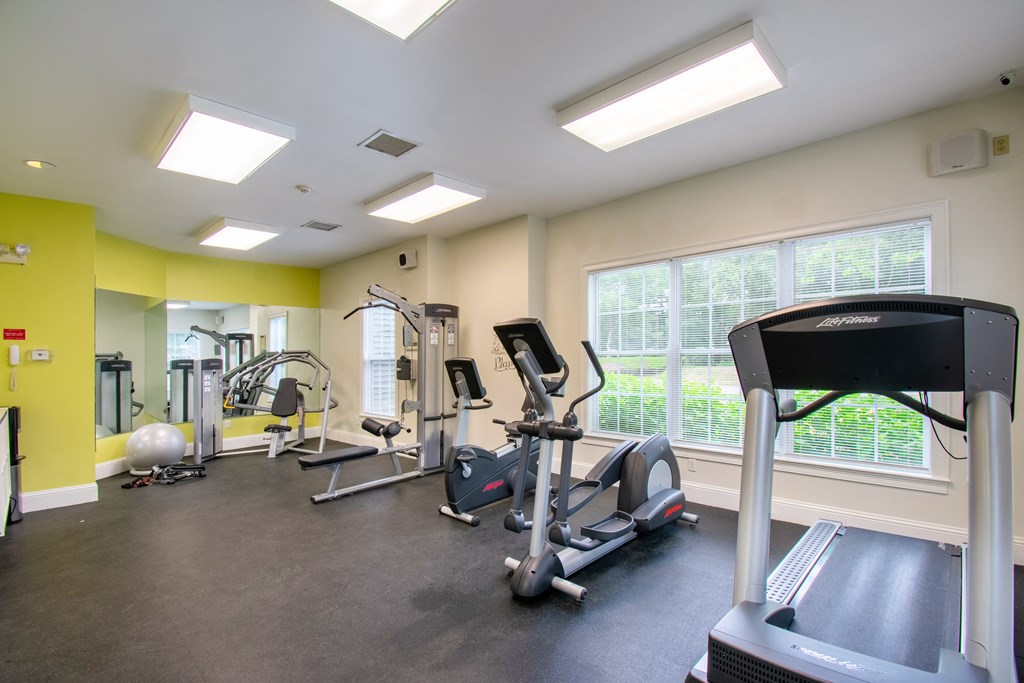 state of the art fitness center with exercise machines and windows at Woodlands at Abington Station, Abington, MA