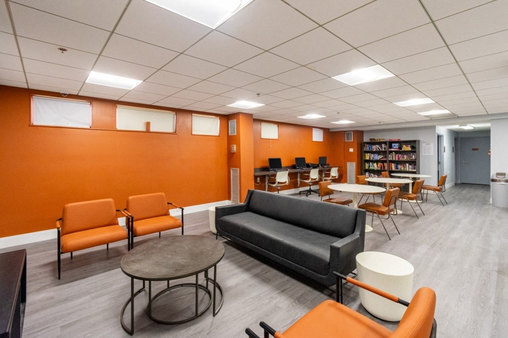 a lounge area in a library with chairs and tables a lounge area in a library with chairs and tables at Mill House Apartments, Greenfield, MA 01301