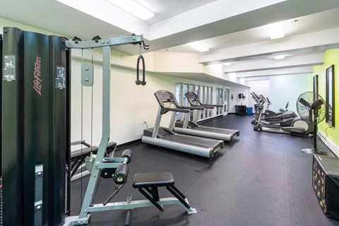 a gym with cardio equipment and weights on the floor at Royal Worcester Apartments, Massachusetts
