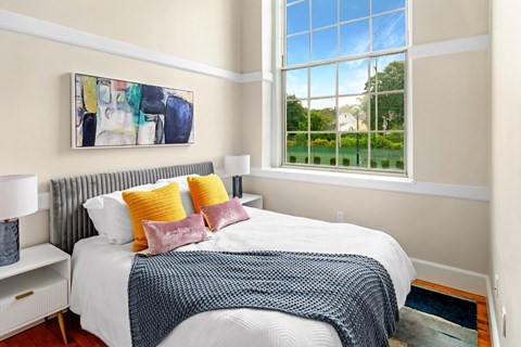 a bedroom with a bed and a large window at Beverly Village for Living & the Arts Apartments, Beverly, 01915