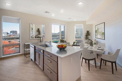 A kitchen with a table and chairs is shown.