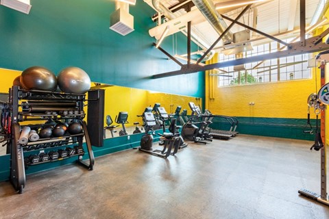 a workout room with weights and other exercise equipment in a gym at Beverly Village for Living & the Arts Apartments, Beverly, 01915