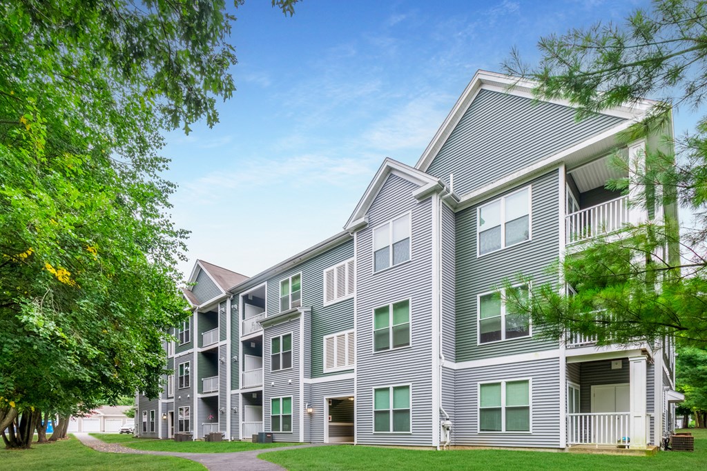 our apartments at the overlook feature a spacious courtyard and green grass at Woodlands at Abington Station, Abington, Massachusetts