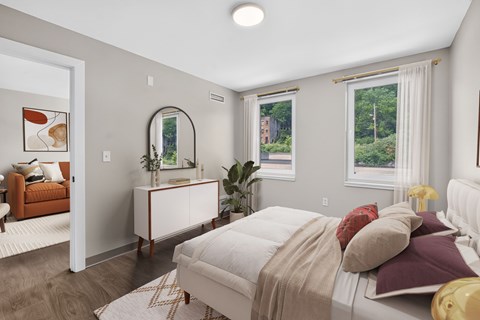 A bedroom with a large bed and a mirror on the wall.