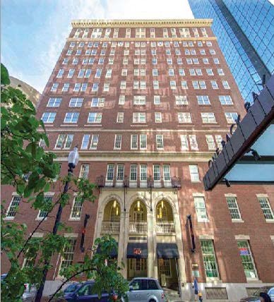 a tall brick building with cars parked in front of it  at 140 Clarendon, Boston, MA