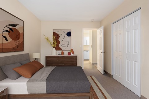 a bedroom with a bed and a dresser and a door to a bathroom at Blue Hills Village, Canton, 02021