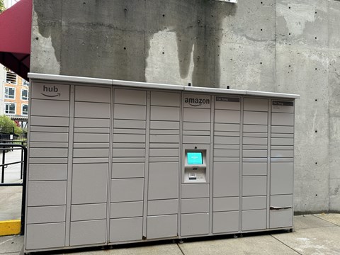 A grey Amazon vending machine with a green screen on the front at Tai Tung Village, Boston, MA 02111