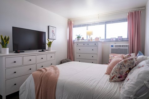 a bedroom with a large bed in front of a window at Dorado Apartments, New York