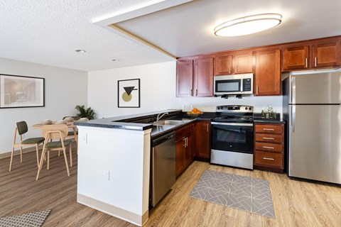 A kitchen with wooden cabinets and stainless steel appliances.