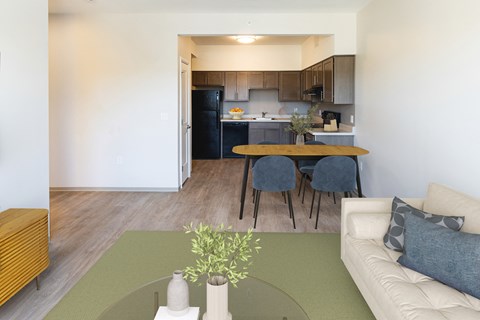 A kitchen with a table and chairs in the foreground.
