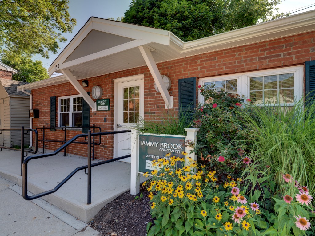 Exterior Of Leasing Office With Garden Tree Shaded Walkway And Landscaped Grounds  Tammy Brook Apartments.