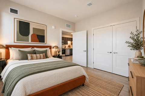 A bedroom with a large bed and a painting on the wall at The Atwater at Ninth Square Apartments, Connecticut 06510