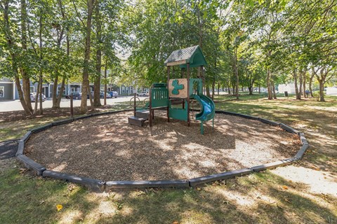 Playground with slide in park area at Woodlands at Abington Station Apartments, Massachusetts