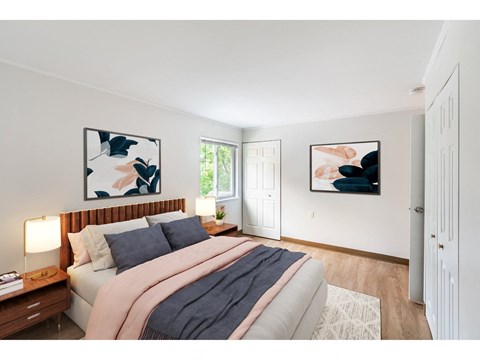 a bedroom with a bed and two paintings on the wall