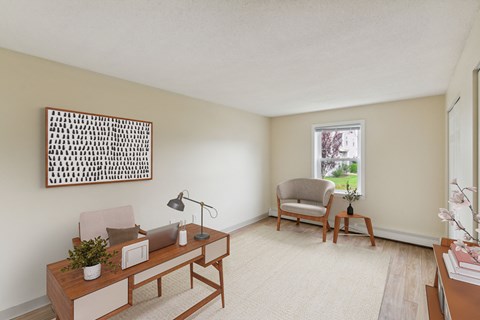 a living room with a desk and a chair and a window at Blue Hills Village, Canton, MA