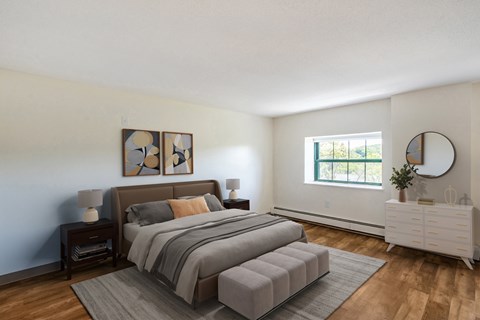 A bedroom with a large bed and a white dresser.