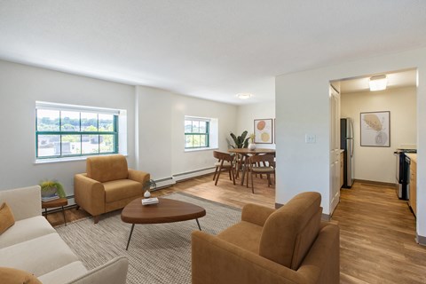 A living room with brown chairs and a brown couch.