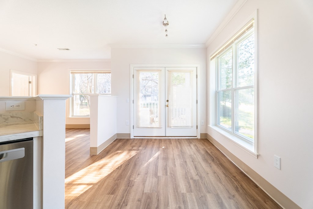 an empty kitchen and living room with hardwood floors at Woodlands at Abington Station, Abington, MA