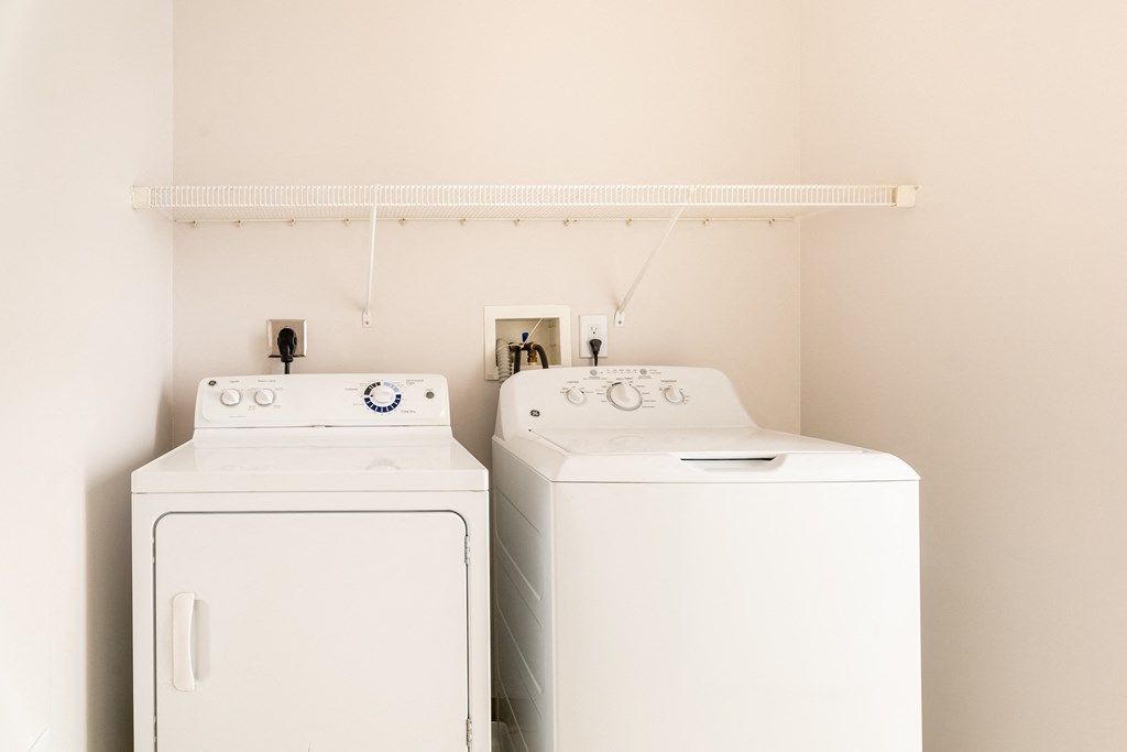 a washer and dryer in a laundry room at Woodlands at Abington Station, Abington, Massachusetts