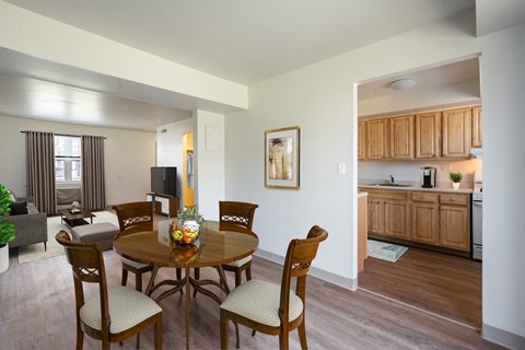 Kitchen With Updated Cabinets and Flooring With Adjacent Dining Room at Georgetowne Homes Apartments, Massachusetts