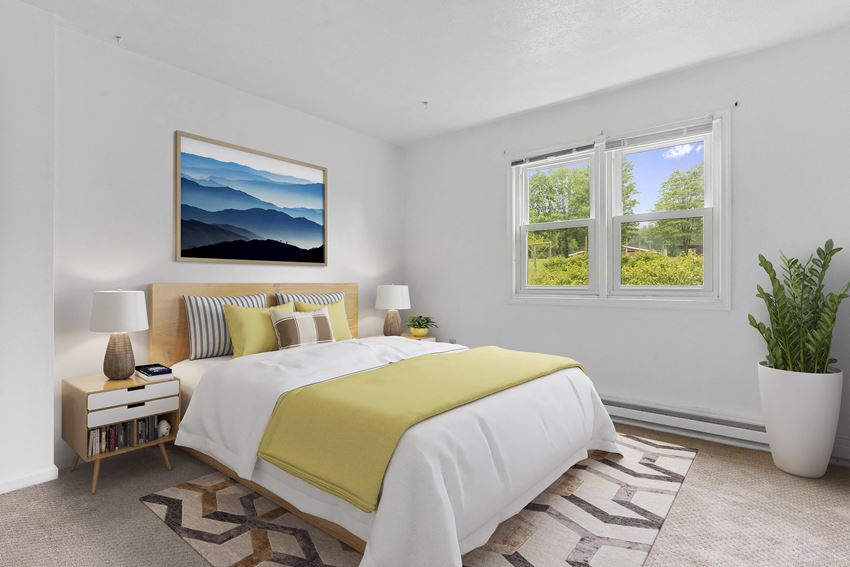 a bedroom with a bed and two windows