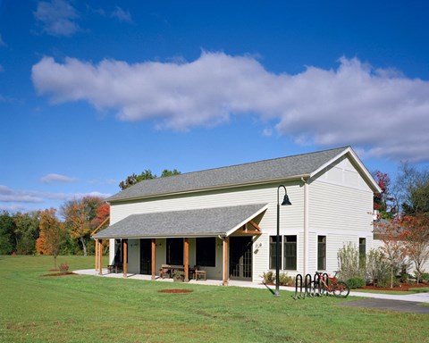 Outdoor Building With Landscaped Grass Yard.