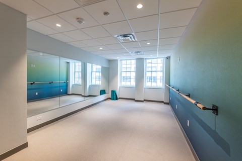 a large room with a large window and a blue wall  at 140 Clarendon, Boston, MA, 02116