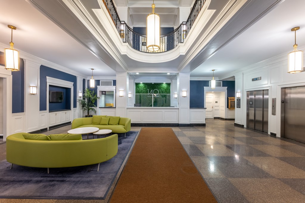 a lobby with blue and white walls and a green couch  at 140 Clarendon, Massachusetts, 02116