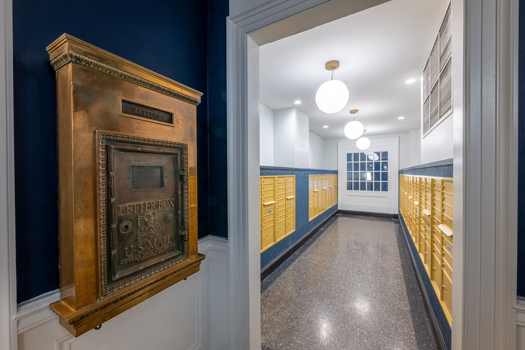 a long hallway with a door to a locker room and a trophy on the wall at 140 Clarendon Street, Boston, MA