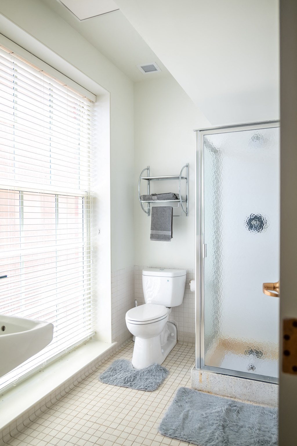 a white bathroom with a shower toilet and sink  at 140 Clarendon, Boston, MA