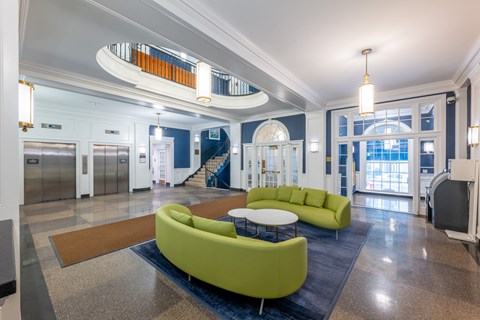 a lobby with couches and a table and a staircase  at 140 Clarendon, Boston, MA