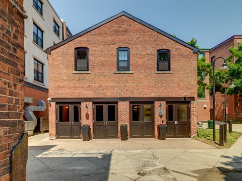 the front of a brick building with three doors at Ninth Square Apartments, New Haven, CT