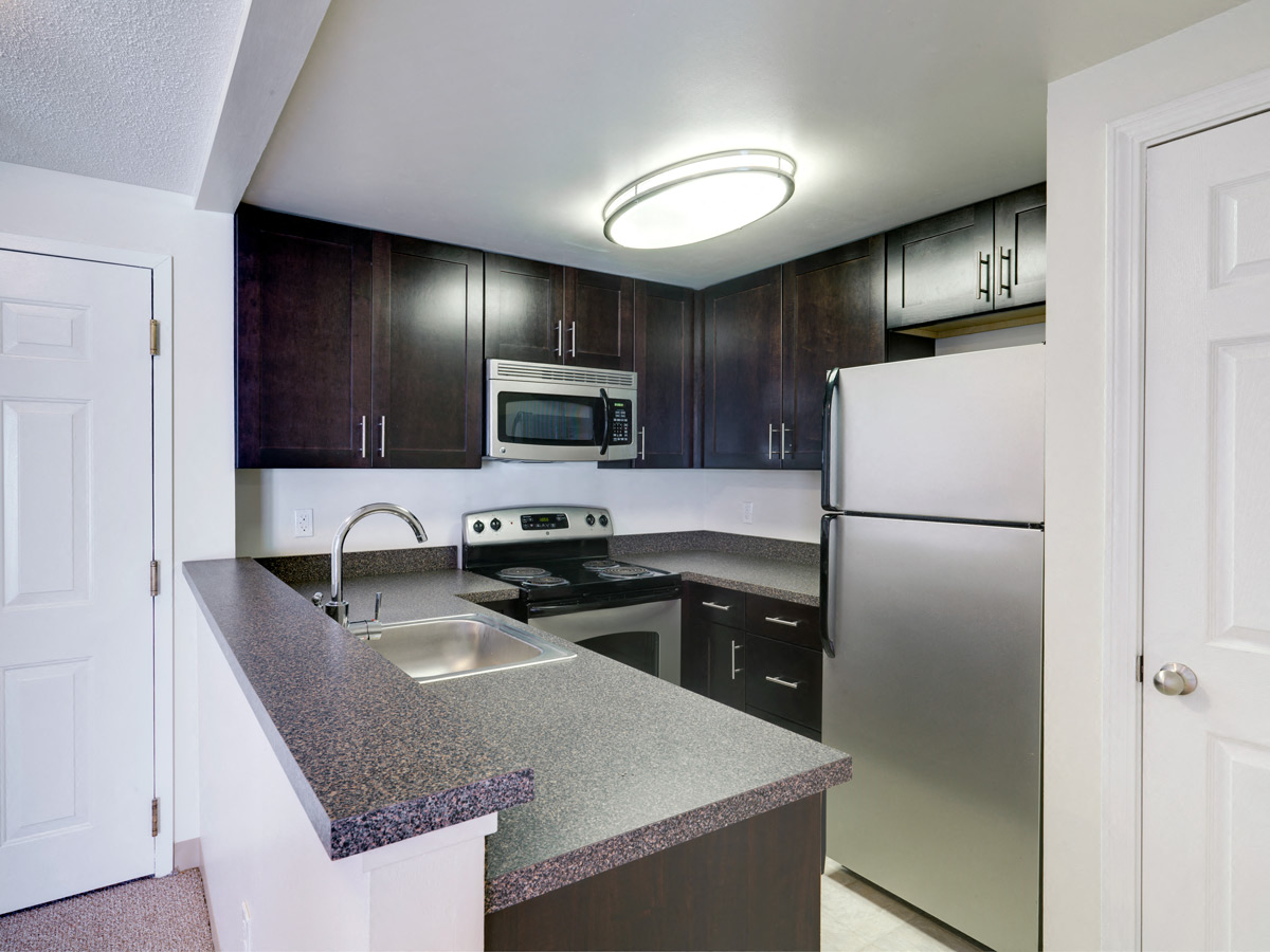 a kitchen with granite counter tops and stainless steel appliances