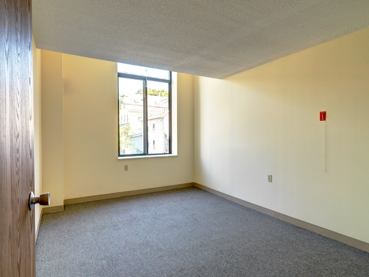 Carpeted Bedroom at Robinson Cuticura Mill Apartments in Malden , MA.